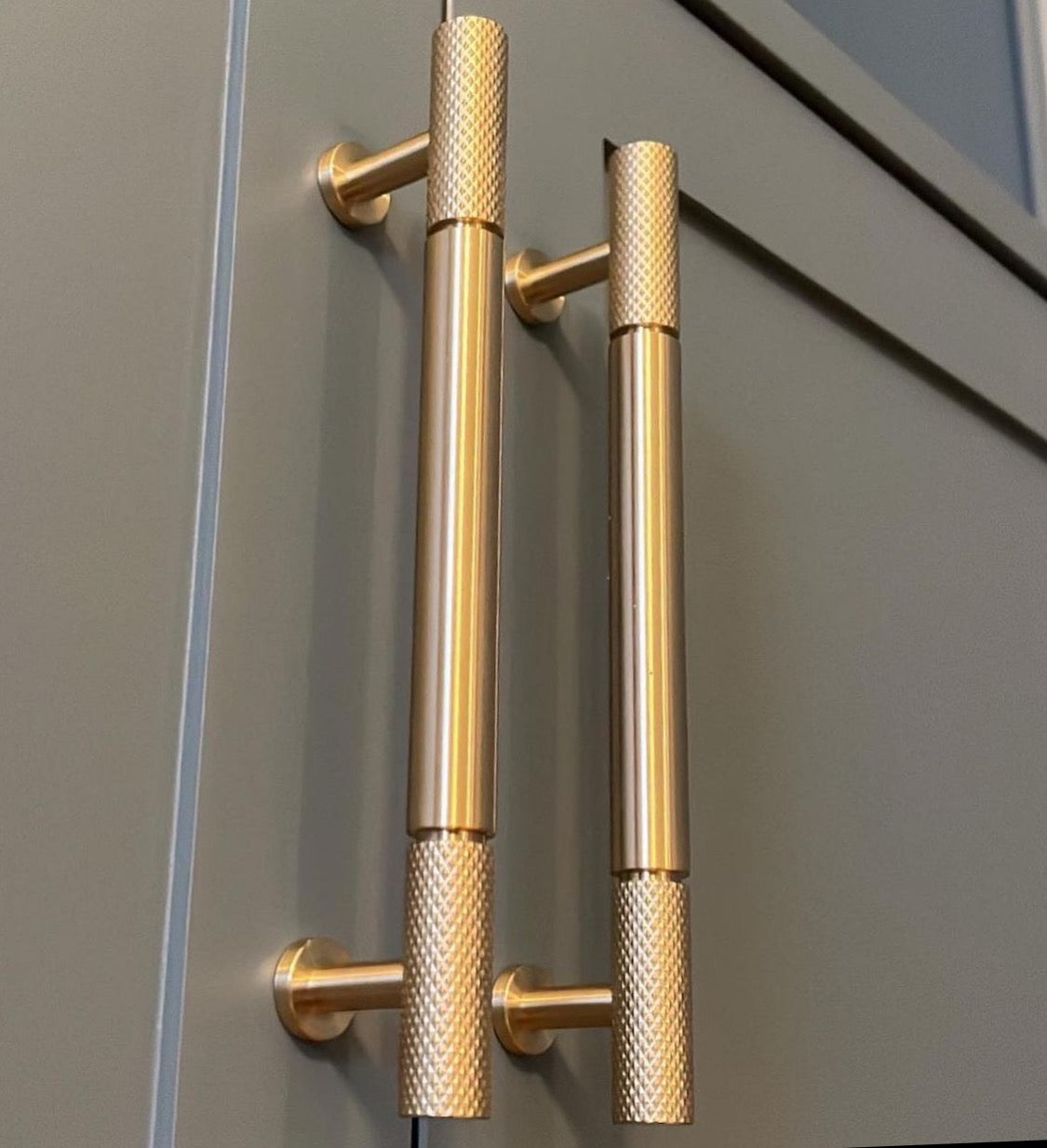Bambino Grande pull bar with signature knurl ends in satin brass on dark grey shaker cabinetry - photo by Inner City Carpentry Ireland