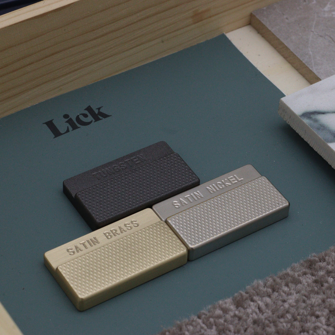 clemo and finch sample finishes with flat knurl - cerakote tungsten sample, satin brass handle swatch, satin nickel architectural hardware