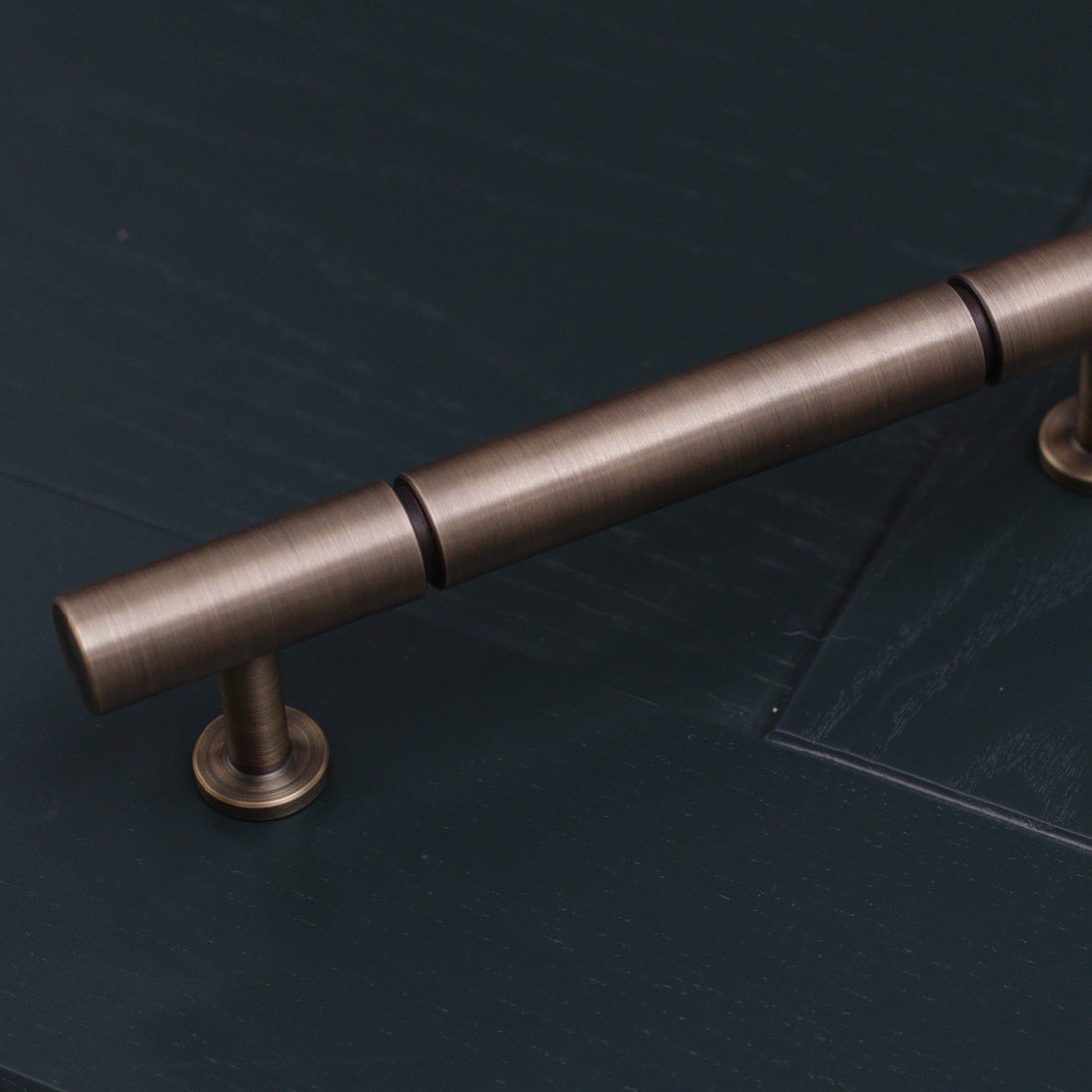 plain antique brushed brass bronze rounded pull handle with indent groove design. perfect minimal handle for kitchens