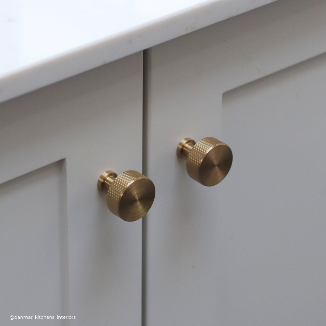 Cranbrook traditional knurled pull handle on grey kitchen cabinetry in satin brass. kitchen design by danmar kitchens in West Malling kent. Kings hill homes, georgie commons freelance photography 