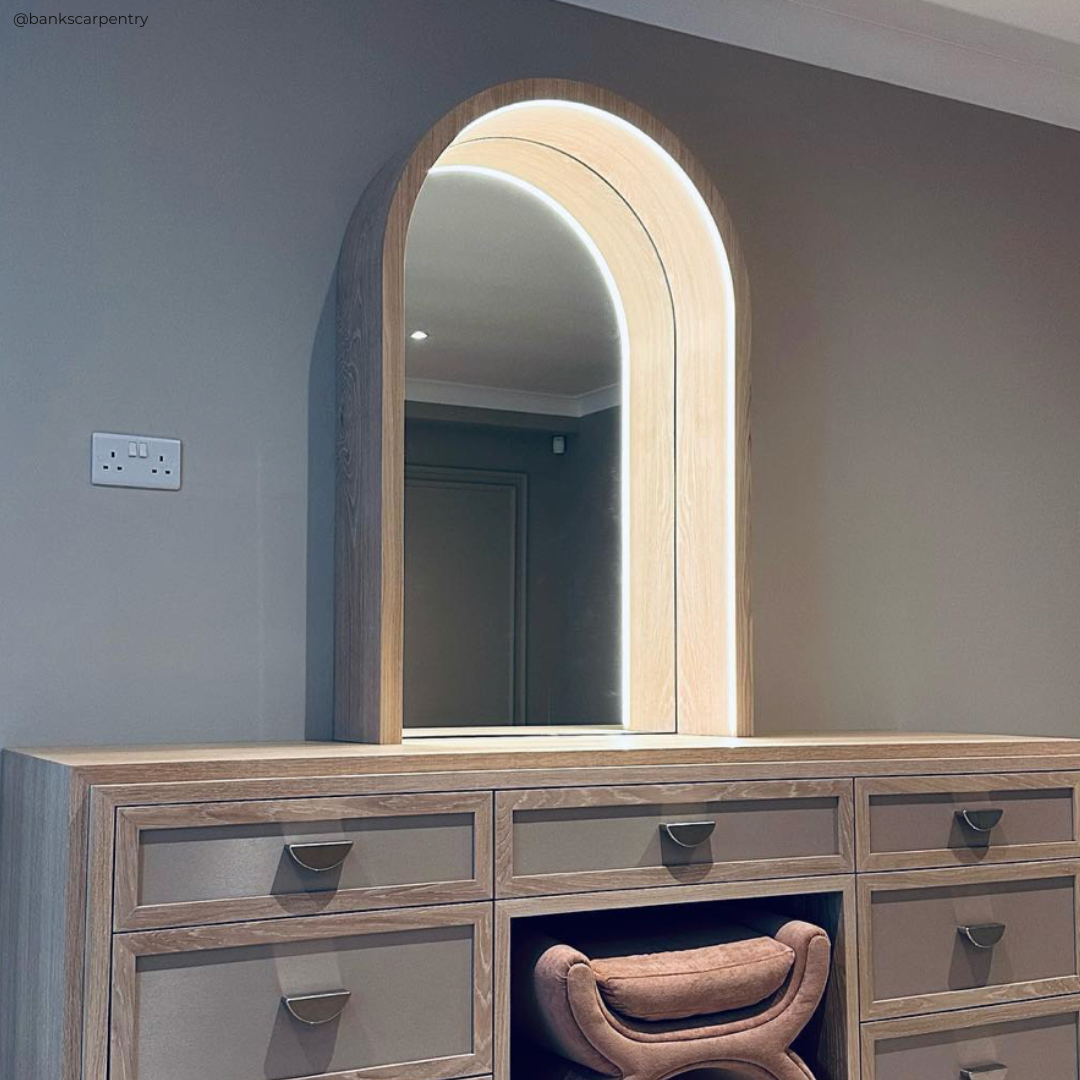gary banks carpentry - festool ambassador. crescent pulls in satin nickel with flat knurl detail on bespoke wooden vanity table with led lighting and rounded mirror. essex carpenters