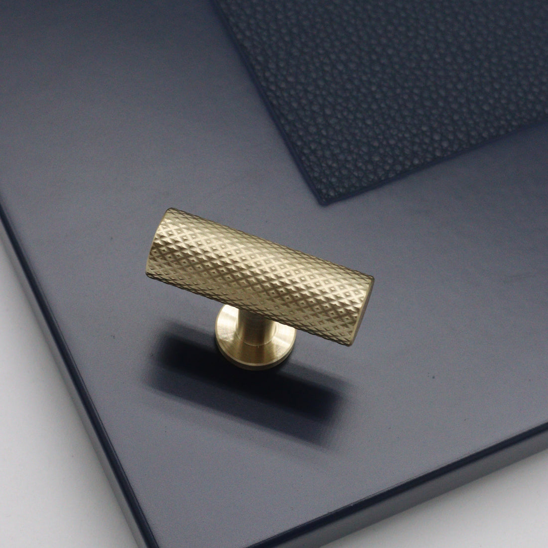 t bar pull handle on dark blue cabinetry