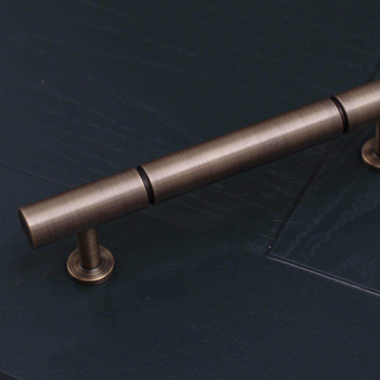 plain antique brushed brass bronze rounded pull handle with indent groove design. perfect minimal handle for kitchens 