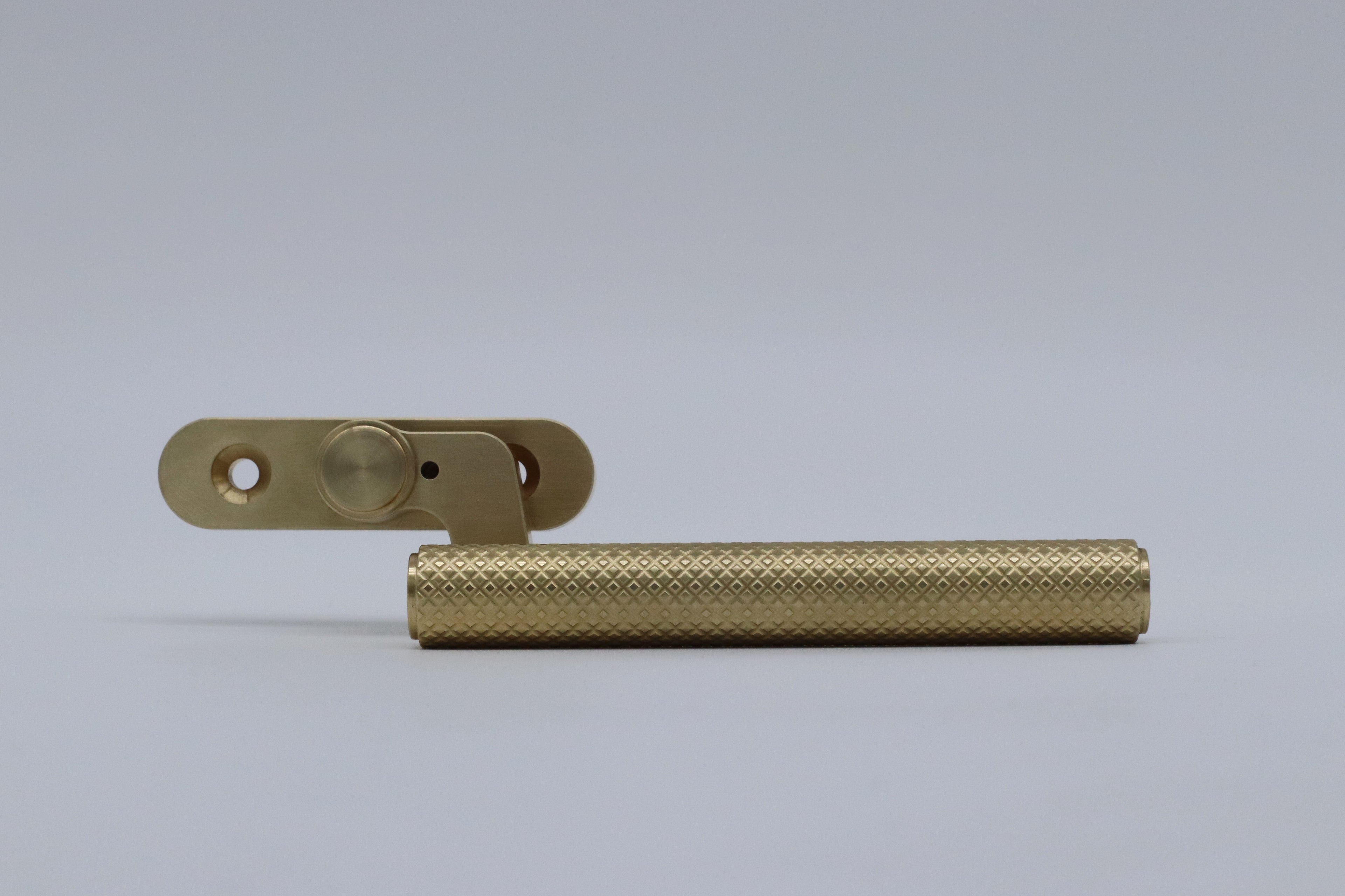 solid brass knurled window handle lever for modern homes. luxury brass ware. luxury window. brass window accessories. solid brass. made in the uk