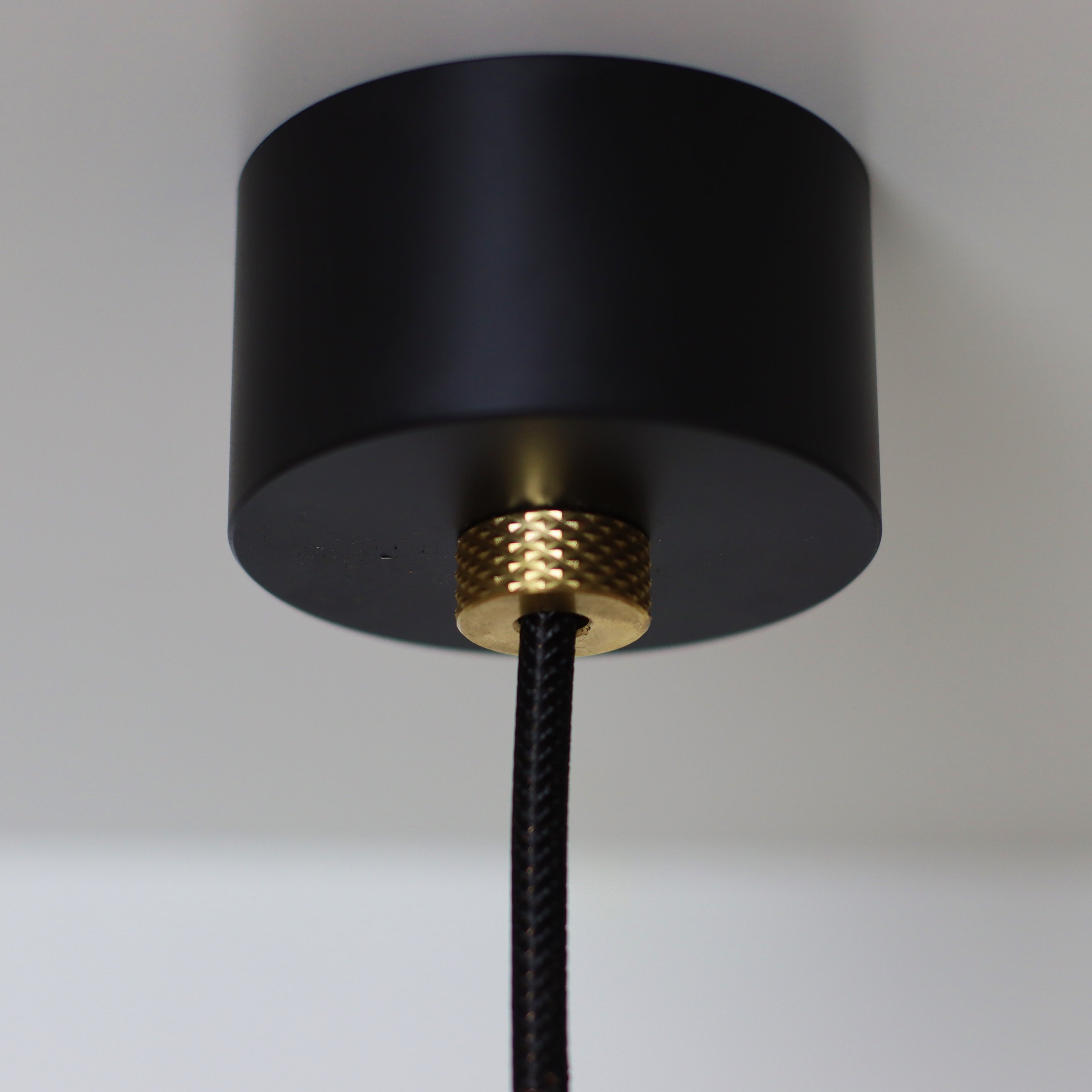 black and brass ceiling rose with fabric four core cable. solid brass knurled accent. decorative lighting. 