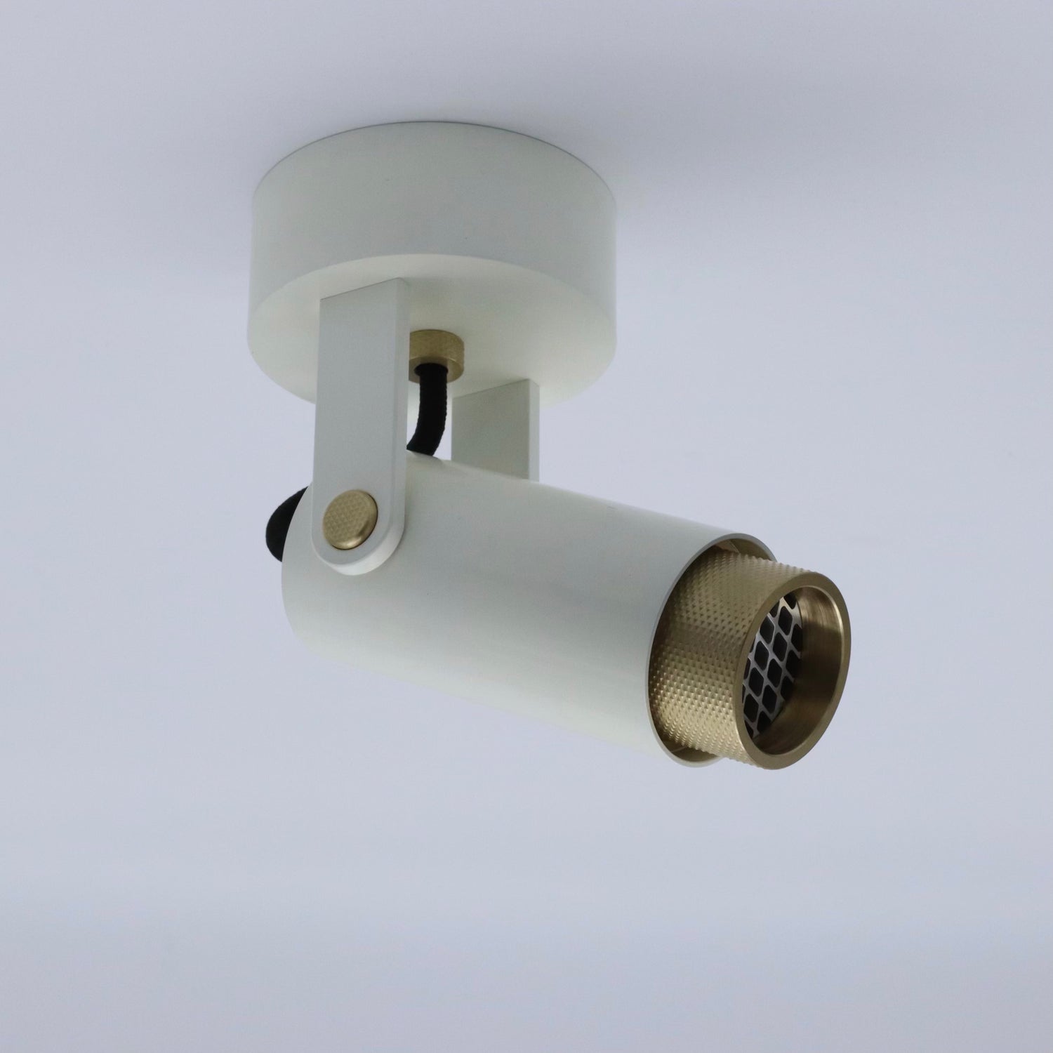ceramic white cerakote finished down facing spot light with solid brass knurling features. ceiling adjustments 